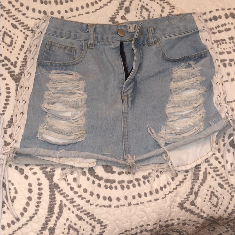 Ripped jean skirt with lace up sides